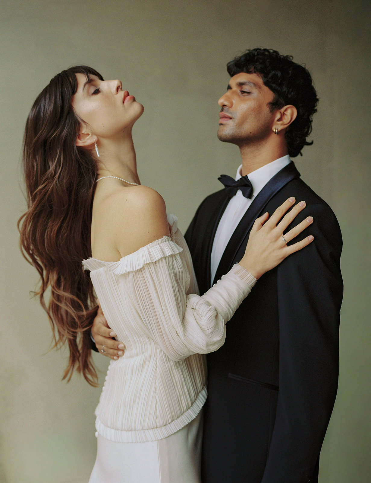 Bride and groom in an embrace, wedding planned and designed by Studio Kowalski
